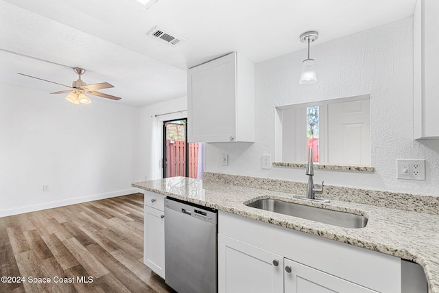 kitchen featuring light wood-type flooring, white cabinets, sink, decorative light fixtures, and dishwasher