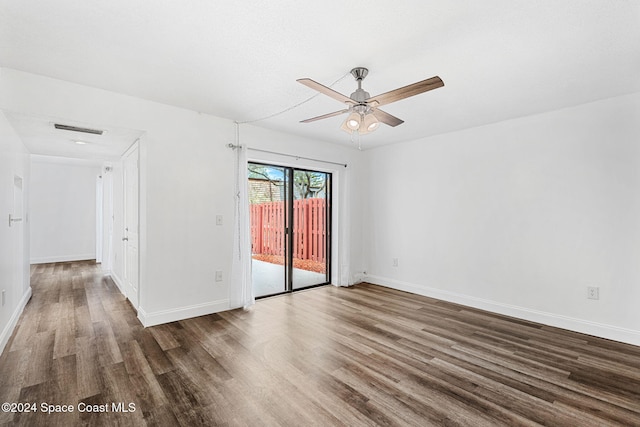 spare room featuring ceiling fan and dark wood-type flooring