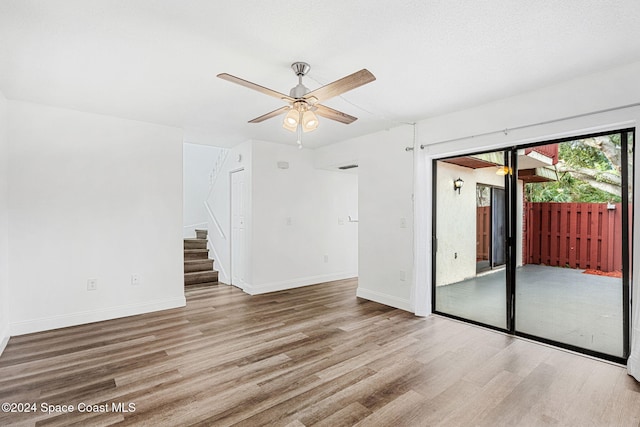 empty room featuring ceiling fan and light wood-type flooring