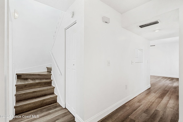 stairs featuring wood-type flooring