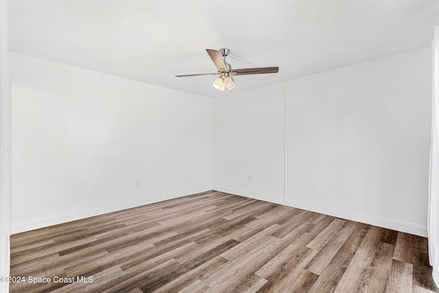 spare room featuring ceiling fan and wood-type flooring