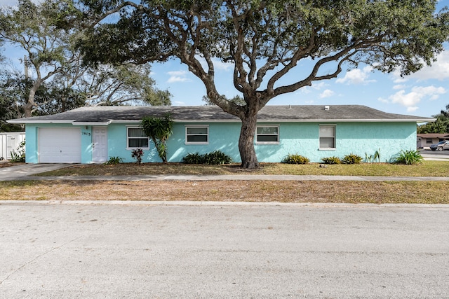 ranch-style home featuring a garage