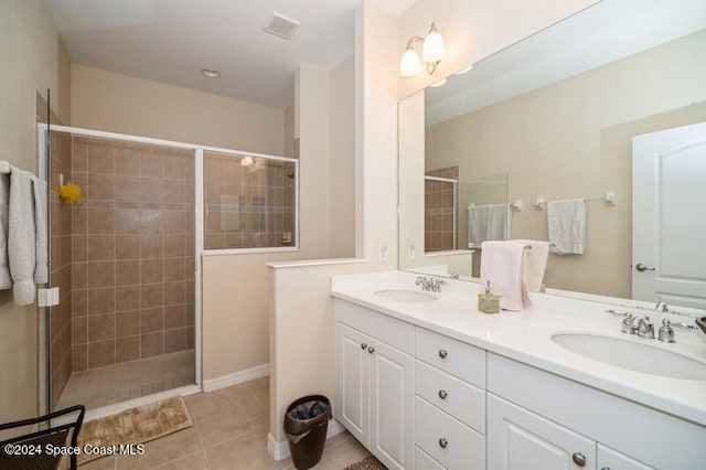 bathroom with tile patterned floors, vanity, and a shower with shower door