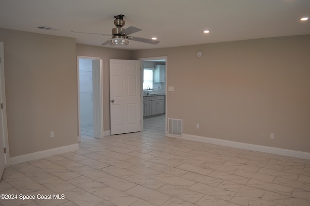 empty room with sink and ceiling fan