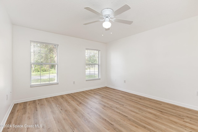 unfurnished room featuring ceiling fan, a healthy amount of sunlight, and light hardwood / wood-style flooring