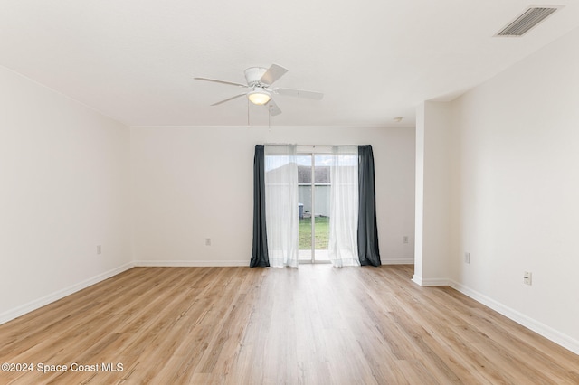 spare room with light wood-type flooring and ceiling fan