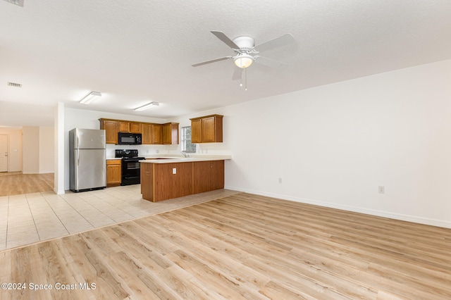 kitchen featuring kitchen peninsula, black appliances, ceiling fan, and light wood-type flooring