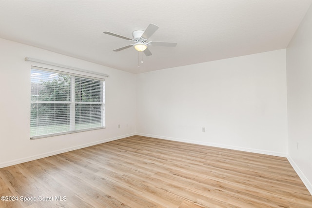 empty room featuring light hardwood / wood-style flooring and ceiling fan