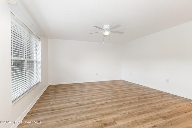 spare room with ceiling fan and light hardwood / wood-style floors