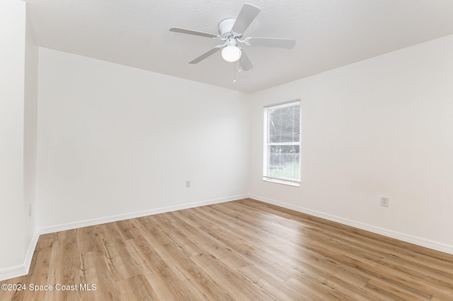 unfurnished room with ceiling fan and light hardwood / wood-style flooring