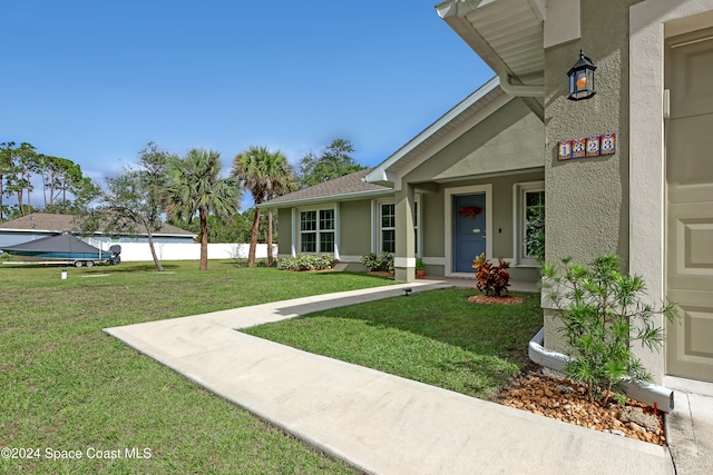 property entrance with a yard