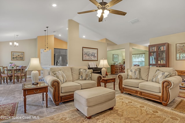 living room featuring ceiling fan with notable chandelier, light tile patterned floors, and vaulted ceiling