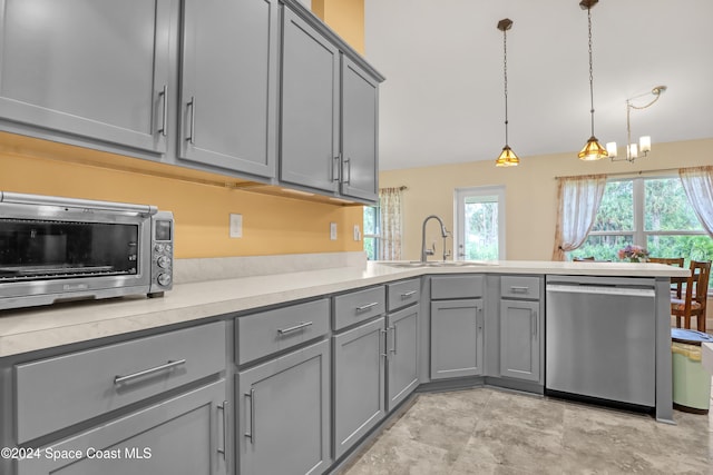 kitchen featuring kitchen peninsula, gray cabinets, decorative light fixtures, stainless steel dishwasher, and sink