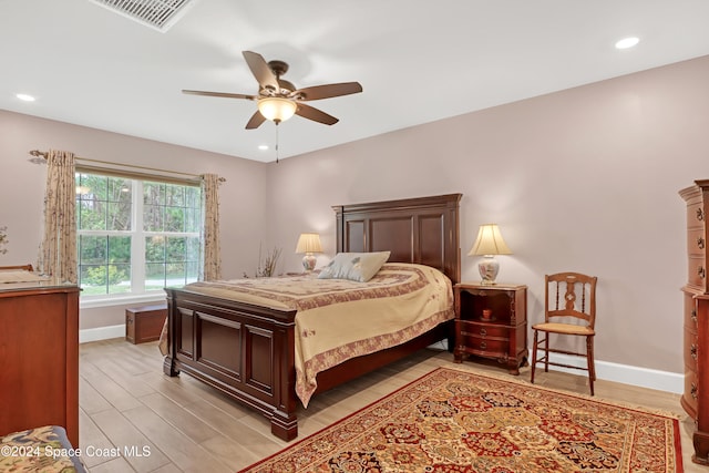 bedroom with ceiling fan and light hardwood / wood-style flooring