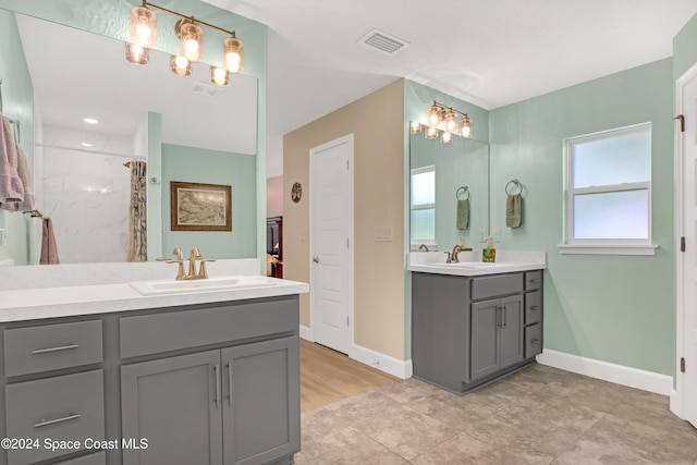 bathroom featuring vanity, a shower with curtain, and a healthy amount of sunlight