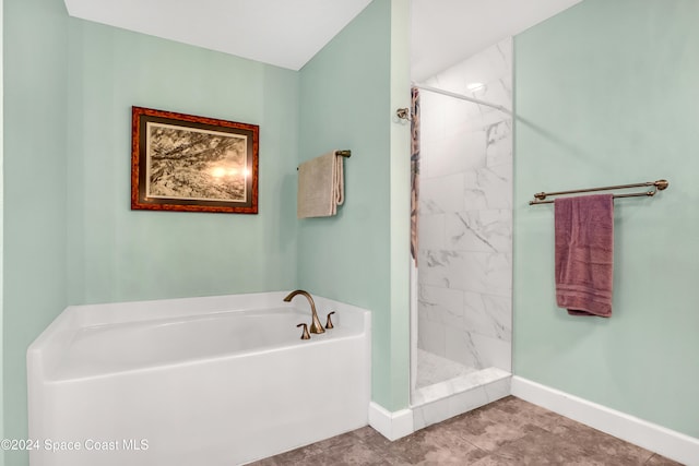 bathroom featuring independent shower and bath