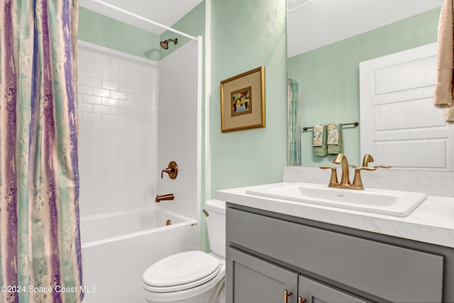 full bathroom featuring toilet, vanity, and shower / bath combo with shower curtain