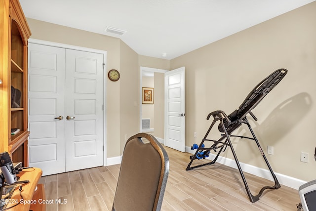 workout area featuring light hardwood / wood-style floors