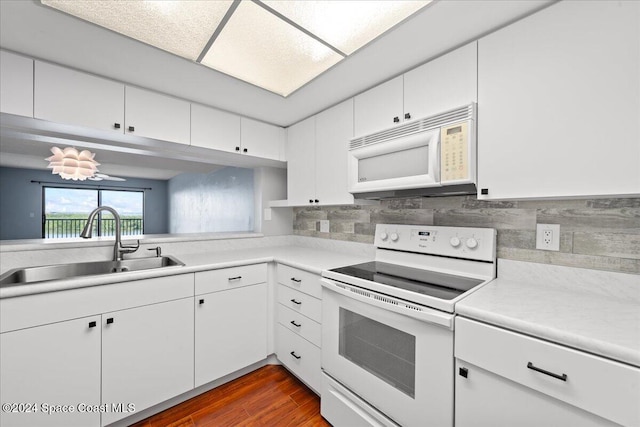 kitchen featuring tasteful backsplash, white cabinetry, dark hardwood / wood-style flooring, sink, and white appliances