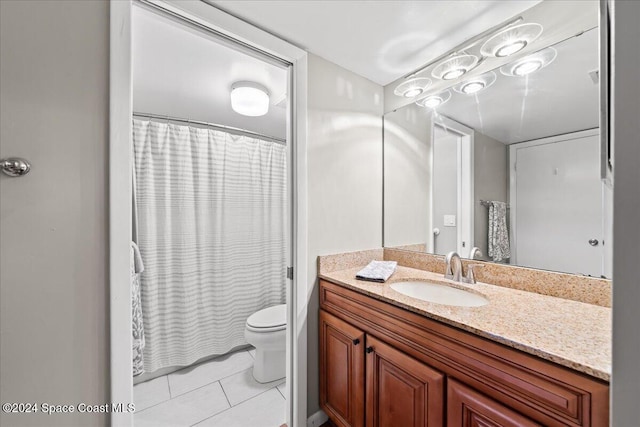 bathroom featuring vanity, tile patterned floors, and toilet