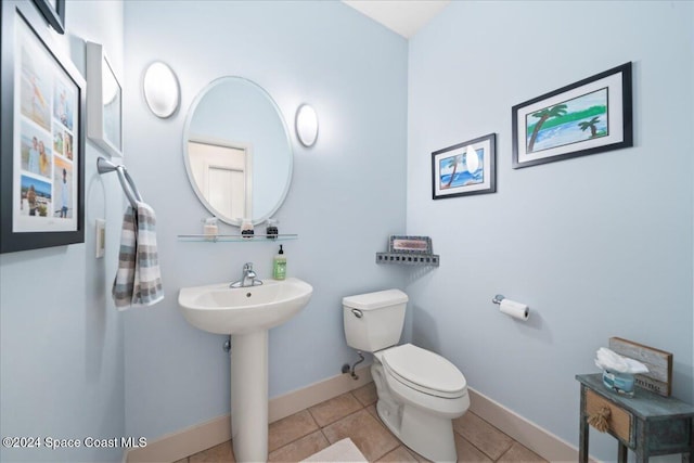 bathroom featuring sink, tile patterned flooring, and toilet