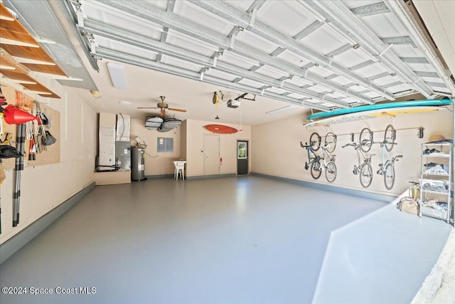 garage featuring heating unit, ceiling fan, a garage door opener, and water heater