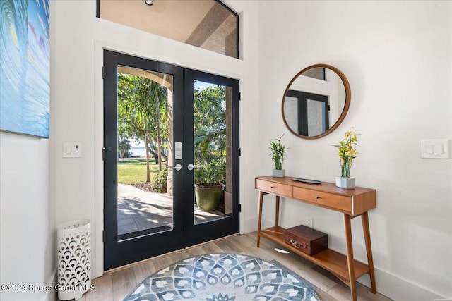 foyer entrance with french doors and light wood-type flooring