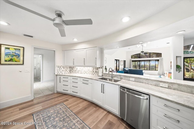 kitchen featuring stainless steel dishwasher, light hardwood / wood-style floors, white cabinets, and sink