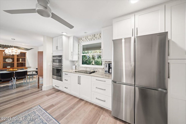 kitchen with light hardwood / wood-style flooring, white cabinets, and appliances with stainless steel finishes