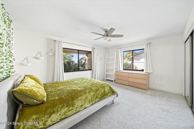 bedroom with ceiling fan, a closet, and carpet floors