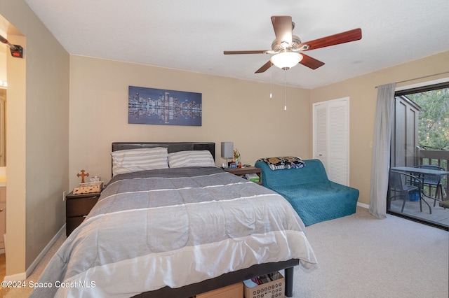 carpeted bedroom with access to exterior, ceiling fan, and a closet