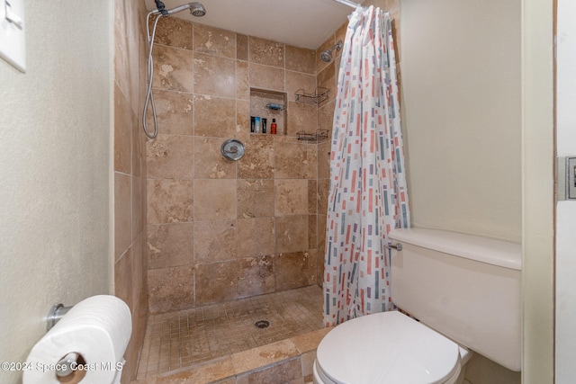 bathroom with curtained shower and toilet