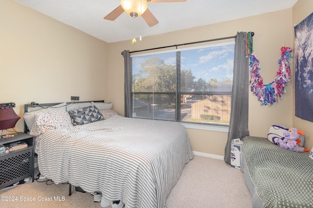 bedroom featuring ceiling fan and light colored carpet