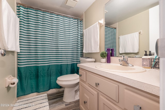 bathroom with vanity, hardwood / wood-style flooring, and toilet