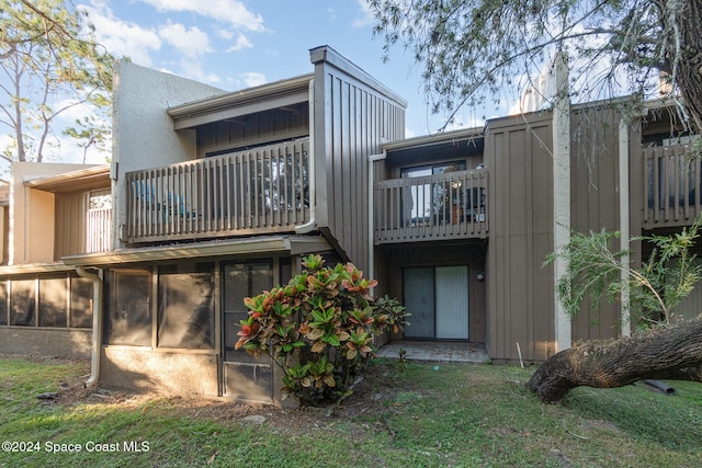 rear view of property featuring a balcony