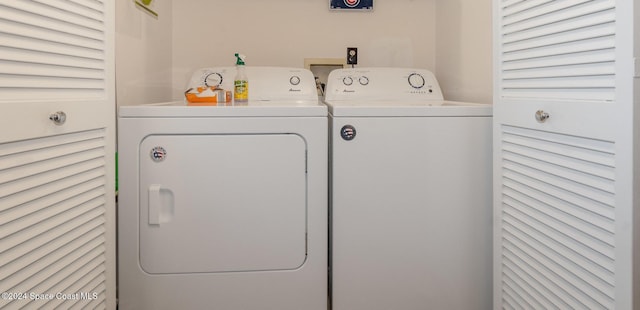 clothes washing area featuring separate washer and dryer