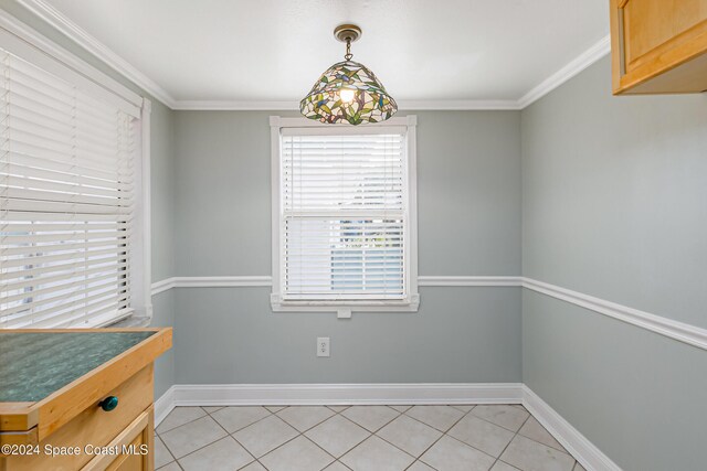 204 Queens Ct, Satellite Beach, FL 32937 - unfurnished dining area featuring light tile patterned floors, crown molding, and baseboards