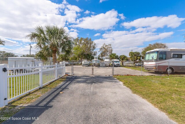204 Queens Ct, Satellite Beach, FL 32937 - view of asphalt driveway with a gate and a gated entry