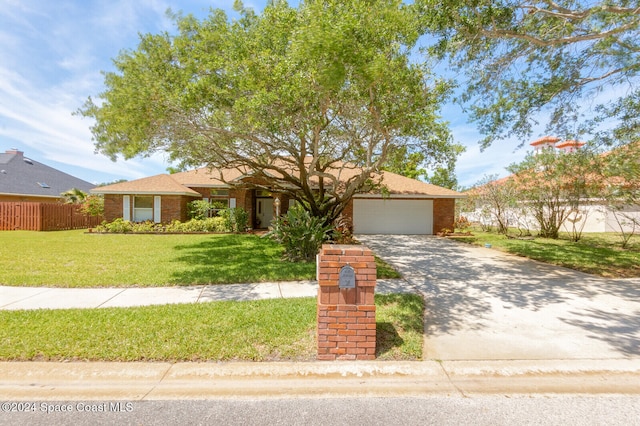 view of front of property featuring a garage and a front lawn