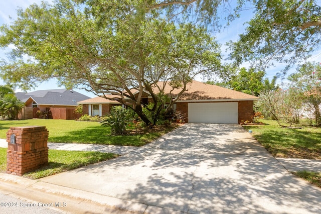 ranch-style house with a front lawn and a garage