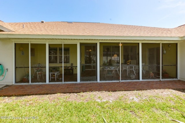 back of property featuring a sunroom