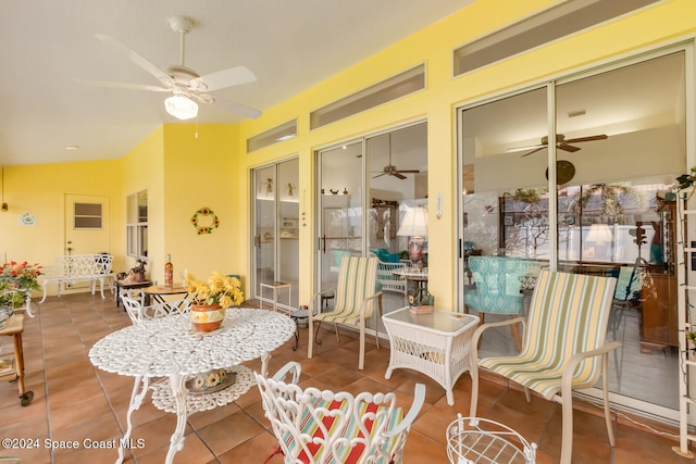 sunroom featuring ceiling fan and vaulted ceiling