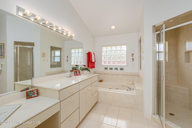 bathroom with lofted ceiling, tile patterned floors, separate shower and tub, and vanity