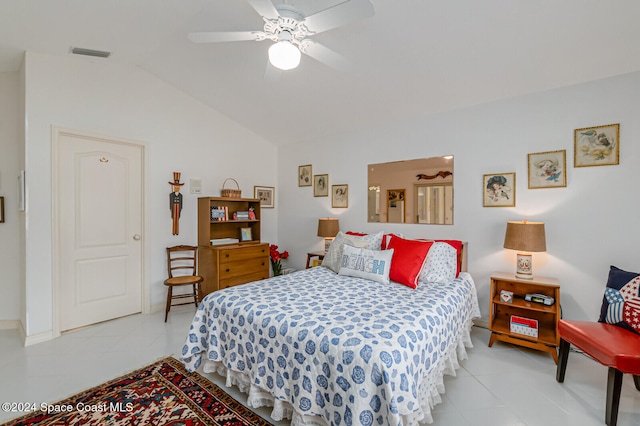 bedroom with ceiling fan, vaulted ceiling, and light tile patterned floors