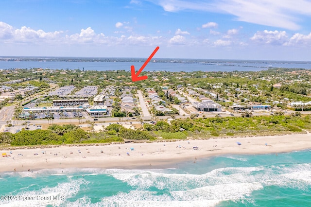 bird's eye view featuring a view of the beach and a water view