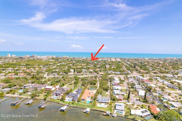 birds eye view of property with a water view