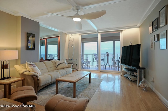 living room with ceiling fan, crown molding, and light hardwood / wood-style flooring