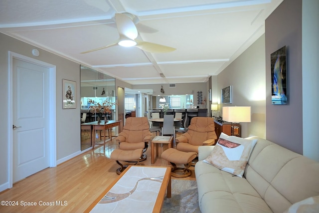 living room featuring ceiling fan, crown molding, and light hardwood / wood-style floors