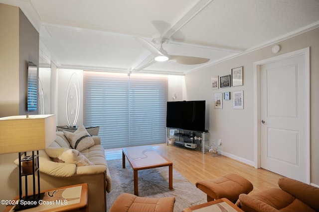 living room featuring hardwood / wood-style flooring, ceiling fan, and ornamental molding