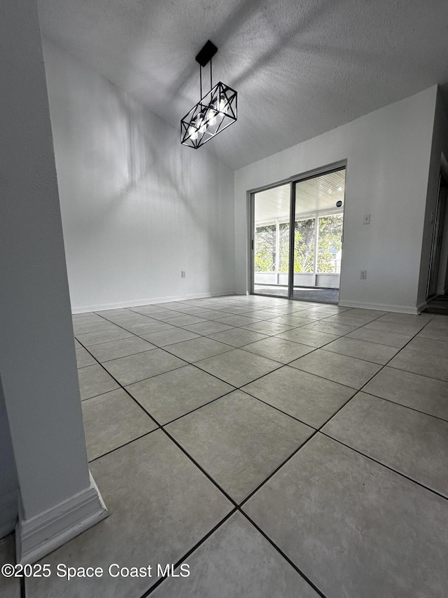 empty room featuring light tile patterned floors and a textured ceiling